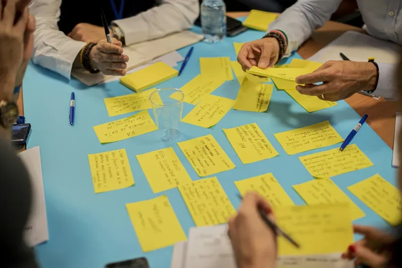 Cross-functional team in a systems mapping workshop with diagrams and collaborative analysis